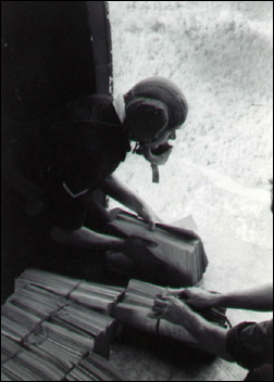 RAF Air Despatcher L/C Ken Thomas of 55 coy AD throws out 