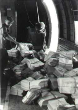 RAF Air Despatcher L/C Ken Thomas of 55 coy AD throws out 